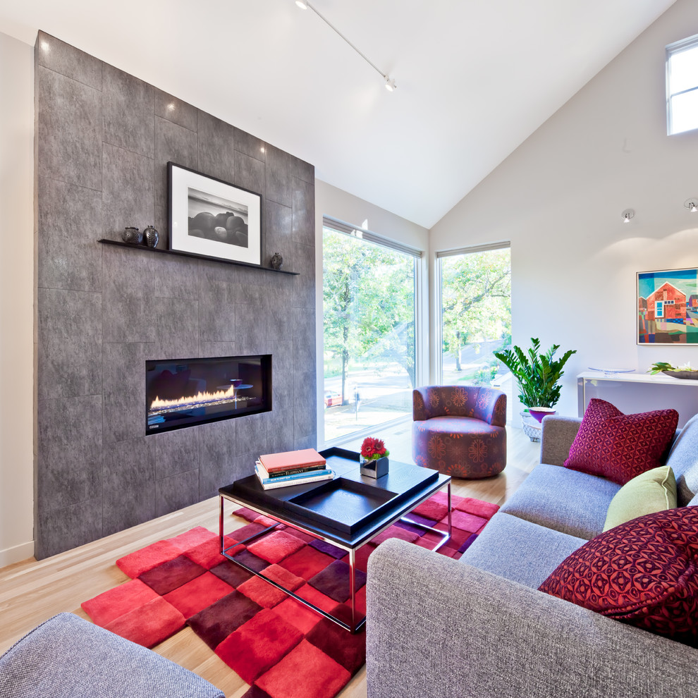 Photo of a mid-sized contemporary formal open concept living room in Minneapolis with grey walls, medium hardwood floors, a ribbon fireplace, a tile fireplace surround, no tv and beige floor.