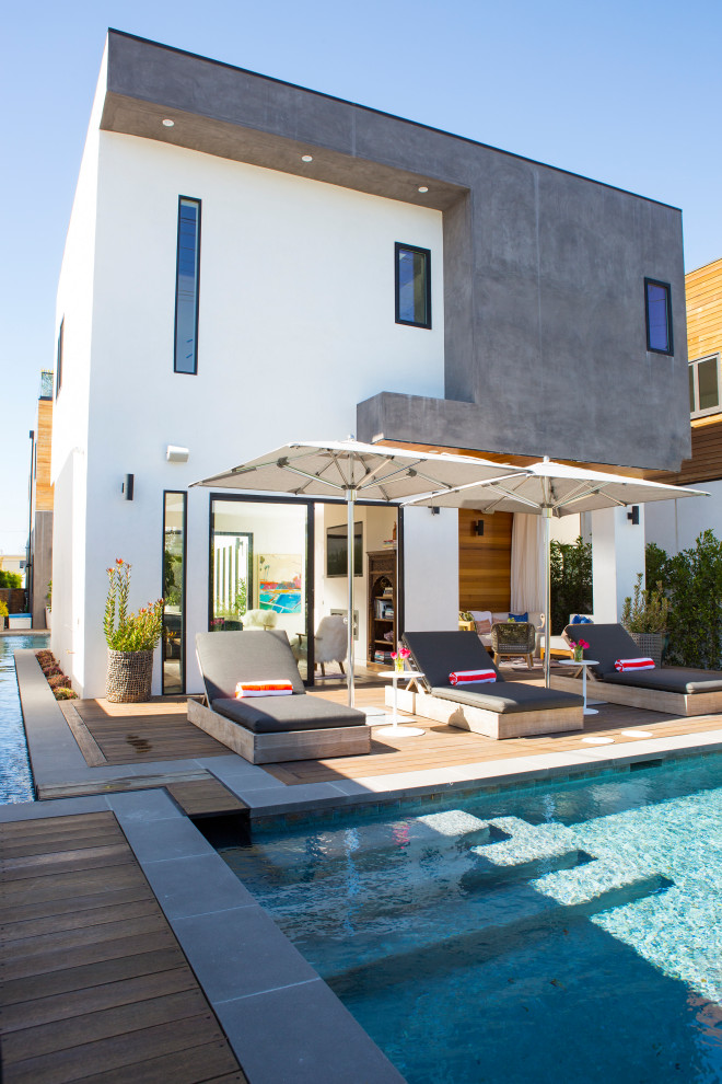 Example of a large minimalist backyard concrete paver and rectangular pool house design in San Francisco