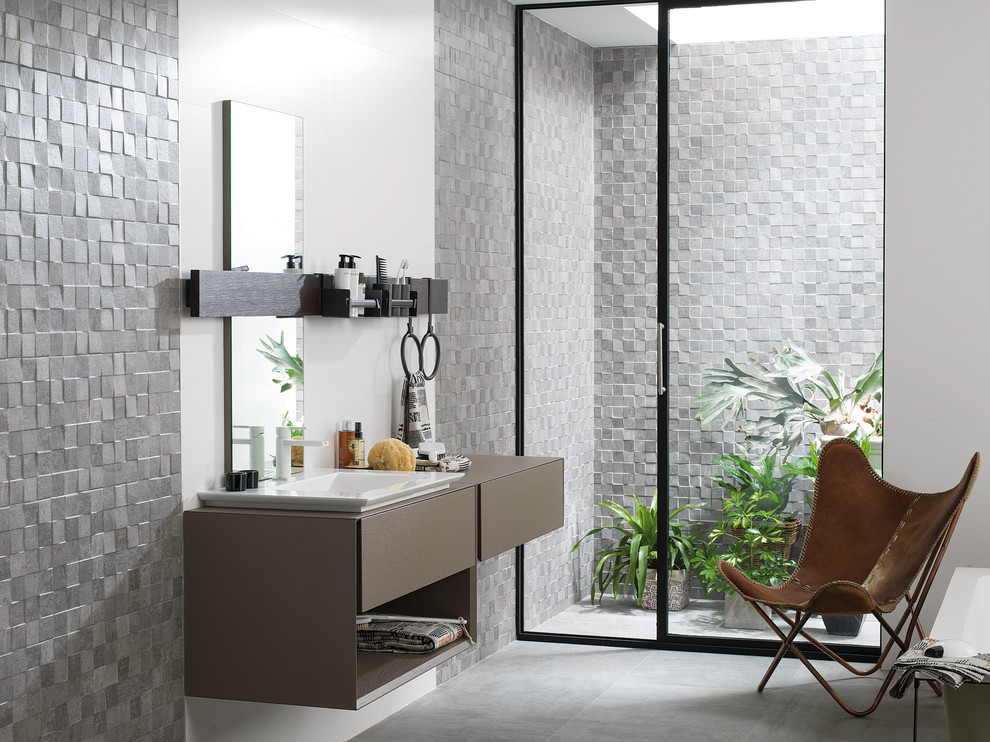 Inspiration for a large industrial bathroom in Perth with gray tile, ceramic tile, porcelain floors, brown cabinets, grey walls, a drop-in sink, flat-panel cabinets and solid surface benchtops.