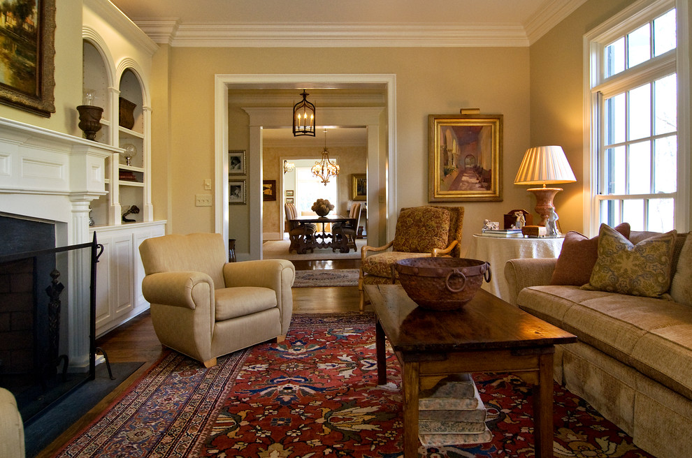 Example of a mid-sized classic formal and enclosed medium tone wood floor living room design in Atlanta with beige walls, a standard fireplace and no tv