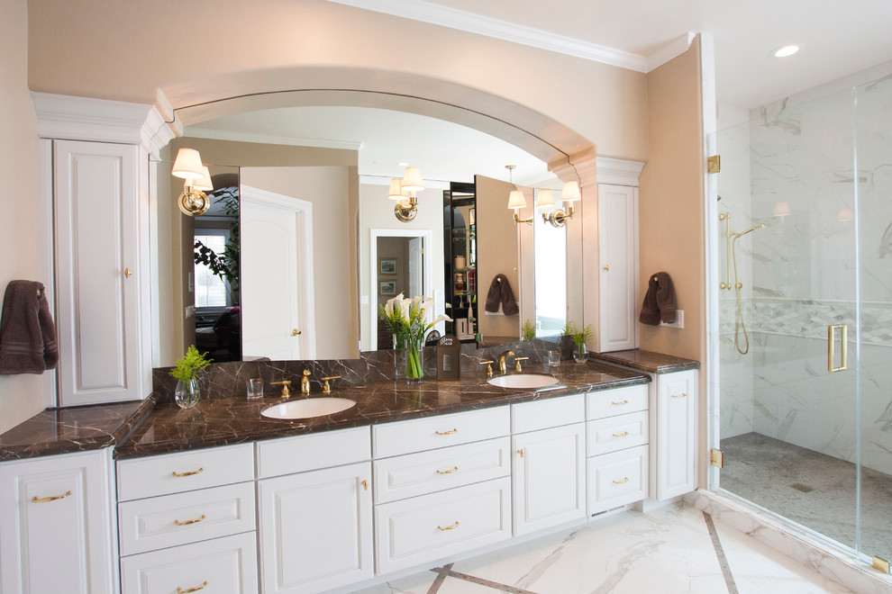 Inspiration for a large transitional master bathroom in Other with white cabinets, porcelain tile, beige walls, an undermount sink, marble benchtops, a corner shower, marble floors, a hinged shower door and recessed-panel cabinets.