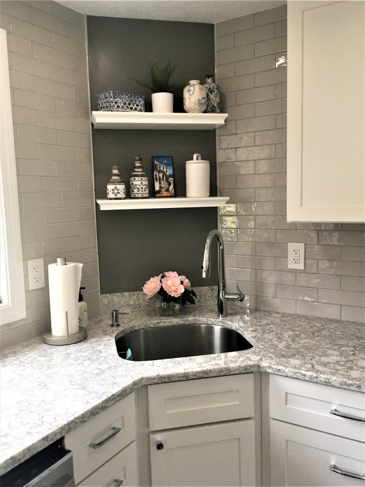 Small transitional u-shaped dark wood floor and brown floor eat-in kitchen photo in Boston with an undermount sink, shaker cabinets, white cabinets, quartz countertops, gray backsplash, subway tile backsplash, stainless steel appliances and gray countertops