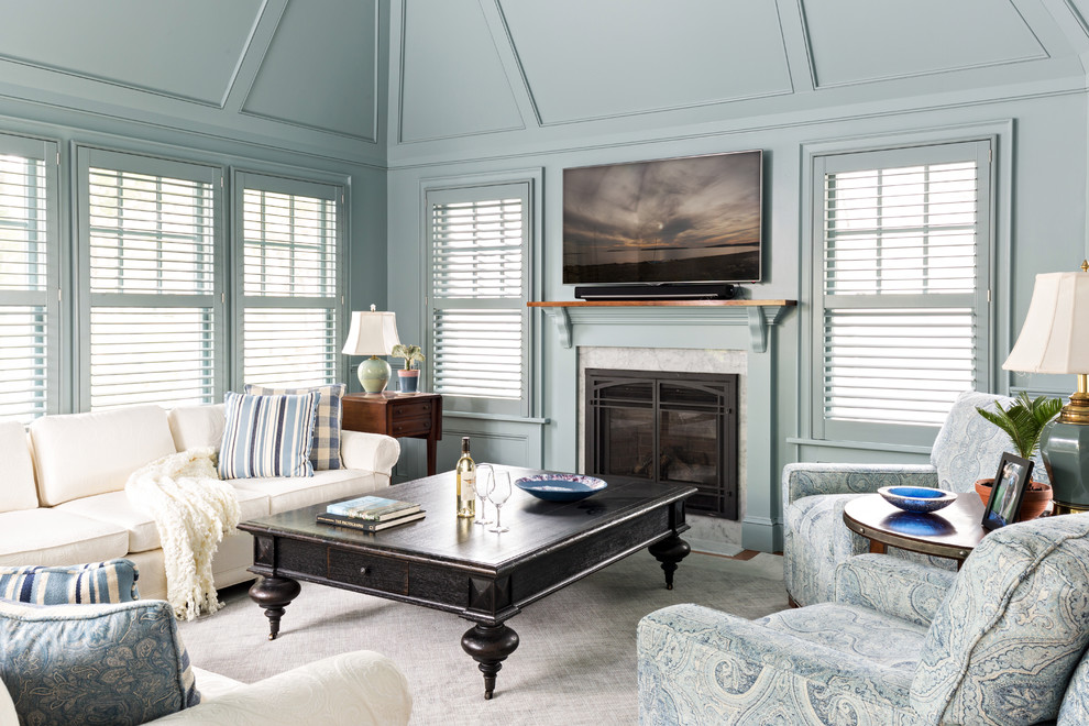 Inspiration for a mid-sized traditional family room in Boston with a standard fireplace, a wall-mounted tv and blue walls.