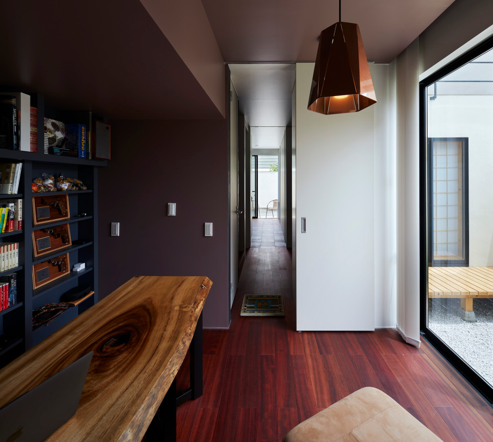 На фото: кабинет в стиле модернизм с фиолетовыми стенами, полом из фанеры и красным полом