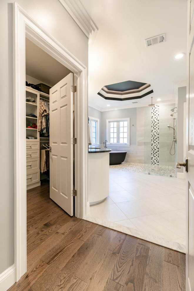 Large contemporary master bathroom in DC Metro with black cabinets, a freestanding tub, an open shower, a one-piece toilet, white tile, white walls, porcelain floors, an undermount sink, multi-coloured floor, an open shower, white benchtops, a shower seat, a single vanity, a built-in vanity and recessed.
