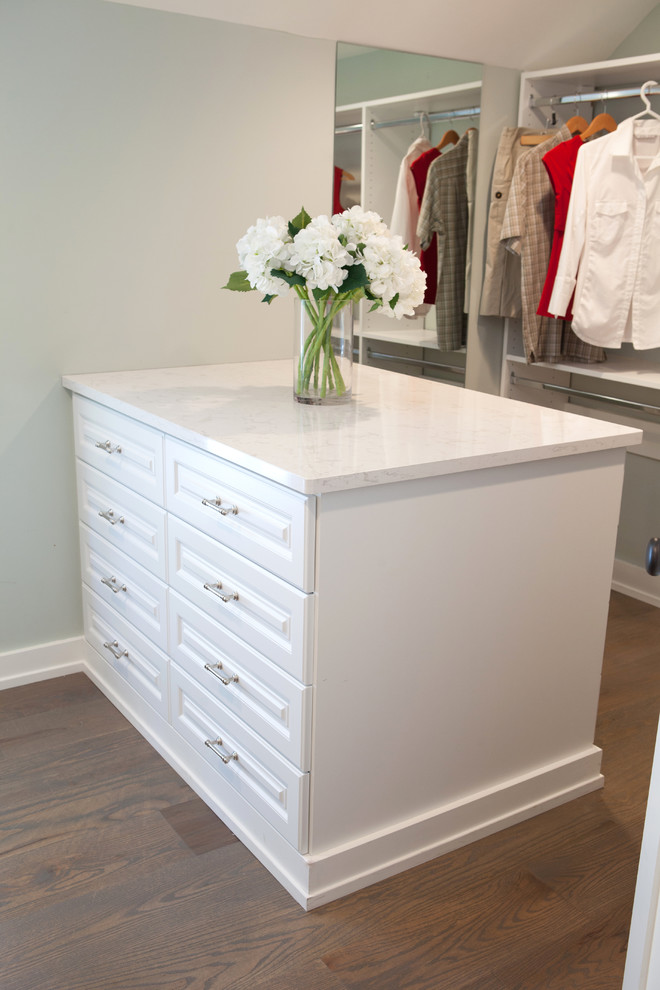 Photo of a large country gender-neutral dressing room in Chicago with white cabinets, medium hardwood floors and raised-panel cabinets.