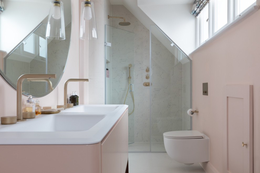 Small midcentury master bathroom in London with flat-panel cabinets, a freestanding tub, an alcove shower, a wall-mount toilet, pink walls, porcelain floors, an integrated sink, solid surface benchtops, a hinged shower door, white benchtops, a double vanity, a freestanding vanity and vaulted.