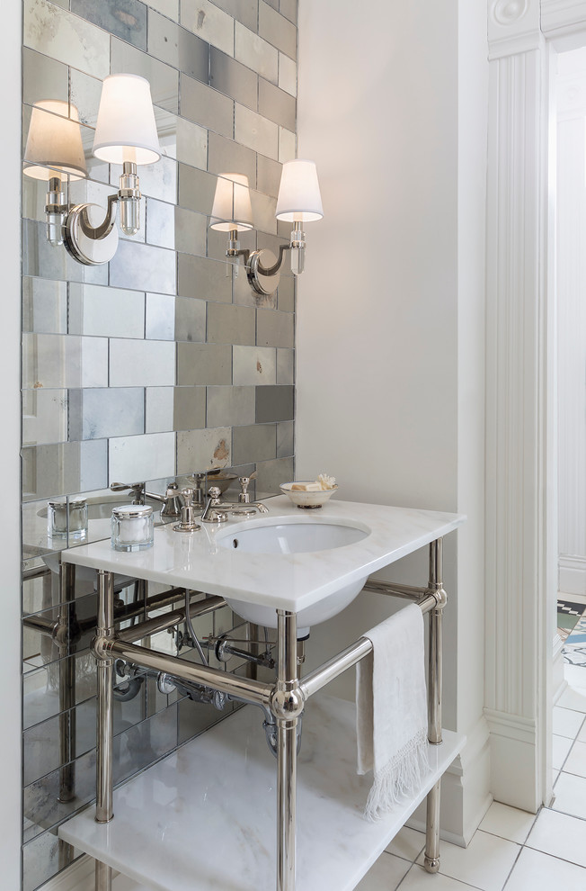 Traditional powder room in Minneapolis with mirror tile and an undermount sink.