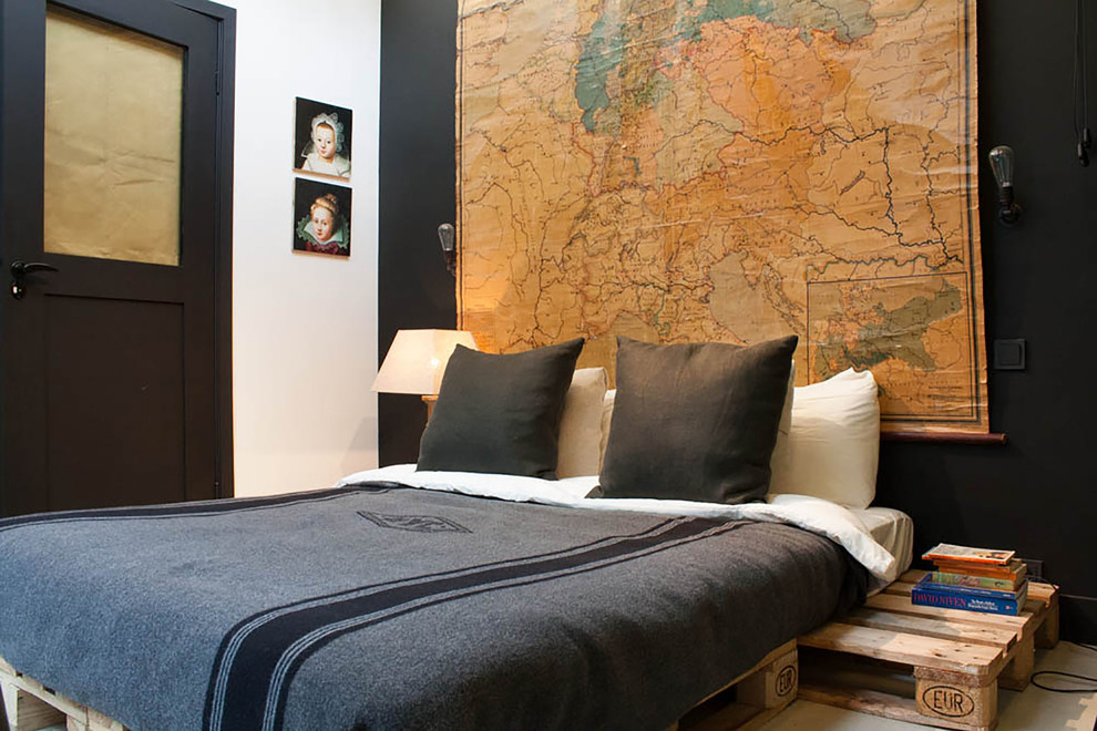 Photo of an industrial bedroom in Amsterdam with black walls.