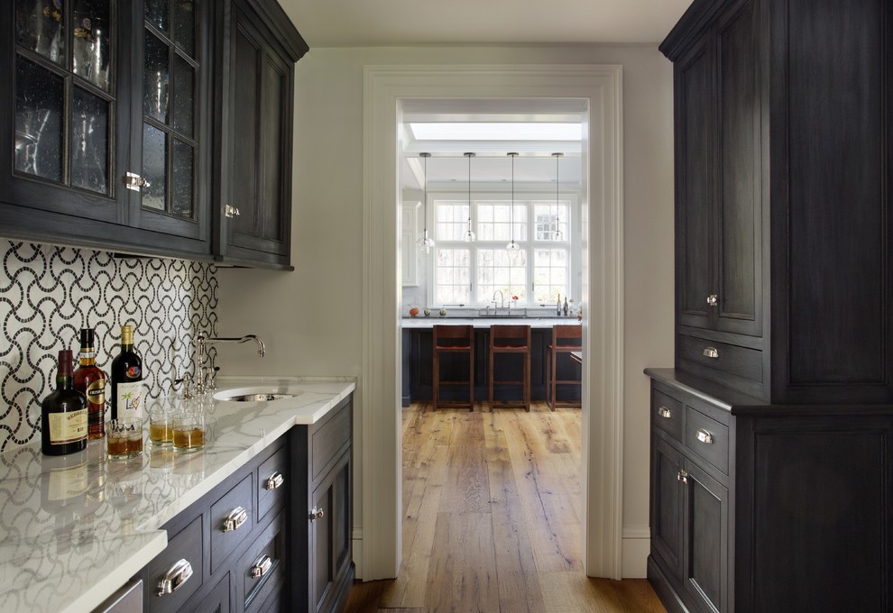 Inspiration for a traditional kitchen in Boston with a single-bowl sink, recessed-panel cabinets and dark wood cabinets.