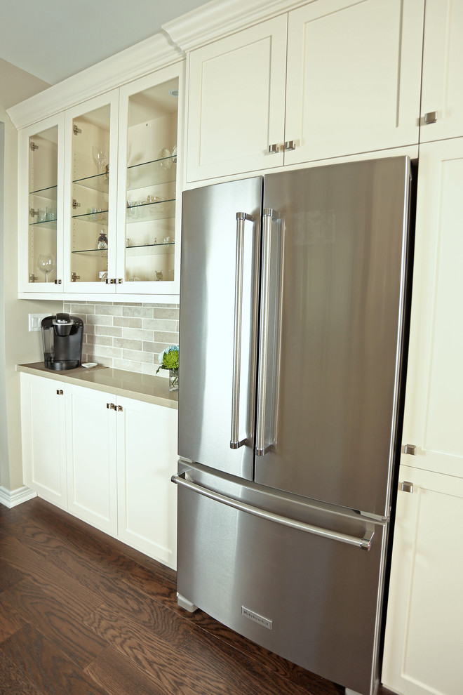 Mid-sized transitional galley dark wood floor and brown floor open concept kitchen photo with an undermount sink, shaker cabinets, beige cabinets, quartz countertops, beige backsplash, porcelain backsplash, stainless steel appliances and no island