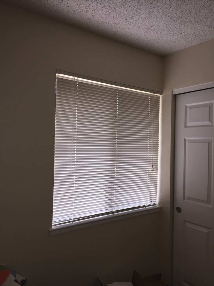 Hanging curtains on a window that butts against a wall or closet