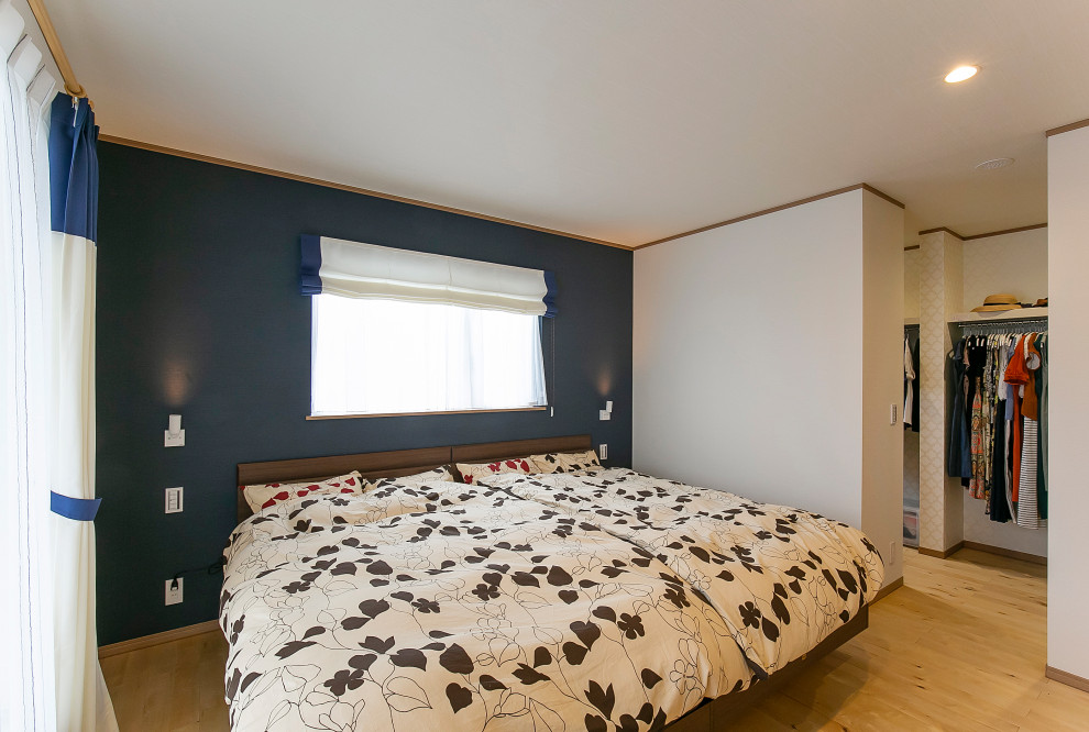 Scandinavian master bedroom in Other with white walls, light hardwood floors, wallpaper and wallpaper.