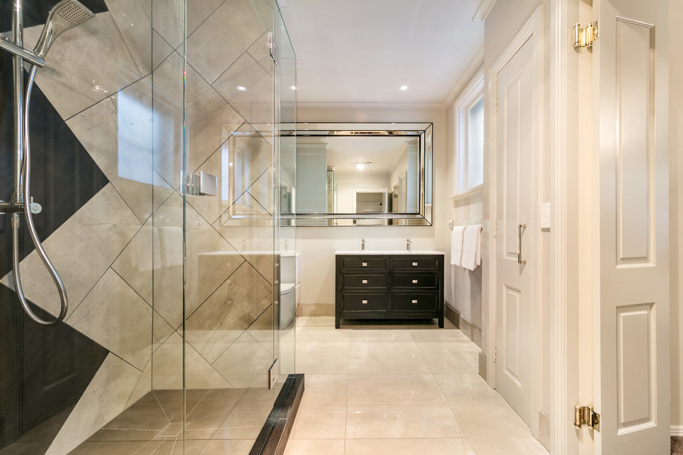 Design ideas for a mid-sized transitional bathroom in Melbourne with furniture-like cabinets, black cabinets, a corner shower, a two-piece toilet, multi-coloured tile, ceramic tile, white walls, ceramic floors, a drop-in sink, solid surface benchtops, beige floor and a hinged shower door.
