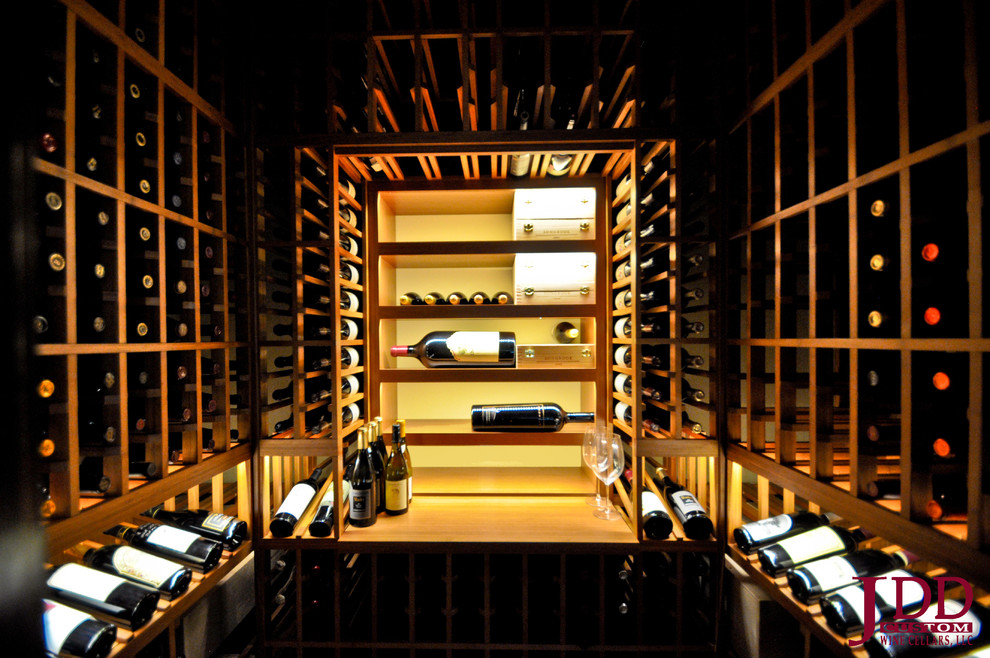 Photo of a mid-sized traditional wine cellar in San Diego with light hardwood floors and storage racks.