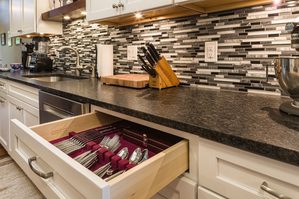 Example of a mid-sized transitional galley medium tone wood floor eat-in kitchen design in Seattle with an undermount sink, shaker cabinets, white cabinets, multicolored backsplash, matchstick tile backsplash, stainless steel appliances and no island