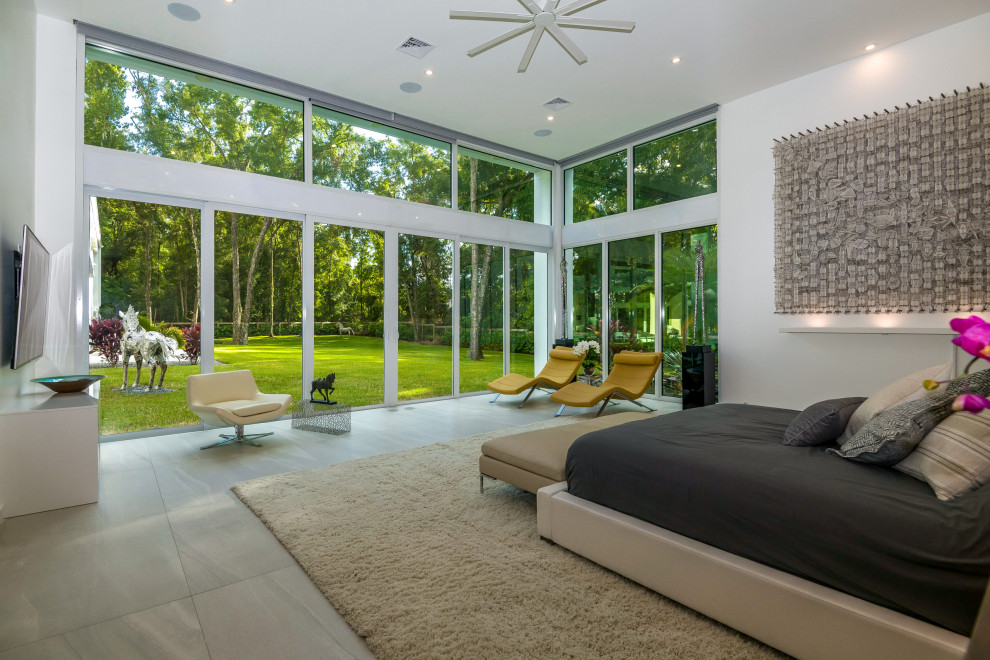 Large contemporary guest bedroom in Other with white walls and grey floor.