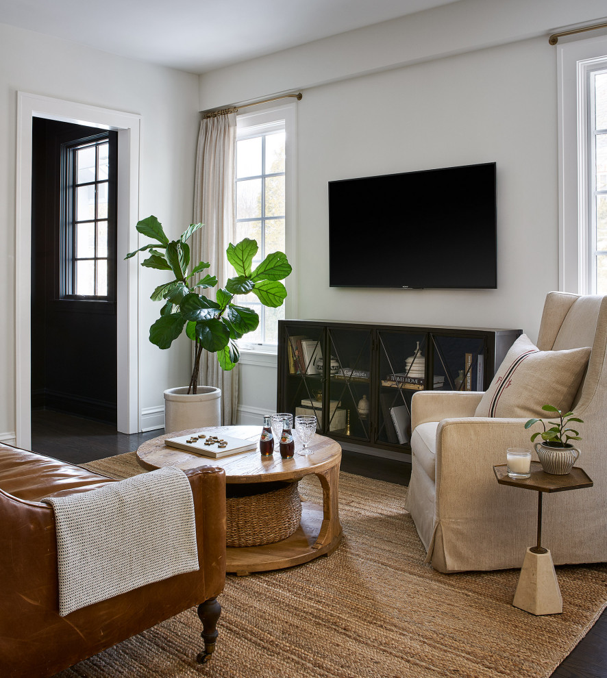 This is an example of a mid-sized transitional open concept living room in Chicago with white walls, medium hardwood floors, a wall-mounted tv and brown floor.
