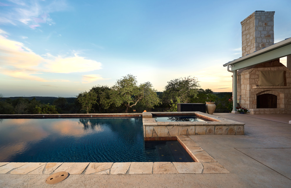 Hot tub - mid-sized rustic backyard stamped concrete and rectangular natural hot tub idea in Austin