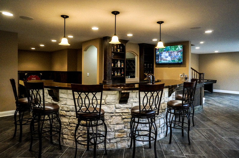 Design ideas for a large country home bar in Chicago.