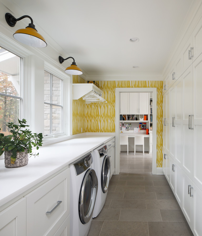 Inspiration for a beach style galley laundry room in Milwaukee with shaker cabinets, white cabinets, quartz benchtops, a side-by-side washer and dryer, grey floor, white walls, white benchtop and wallpaper.