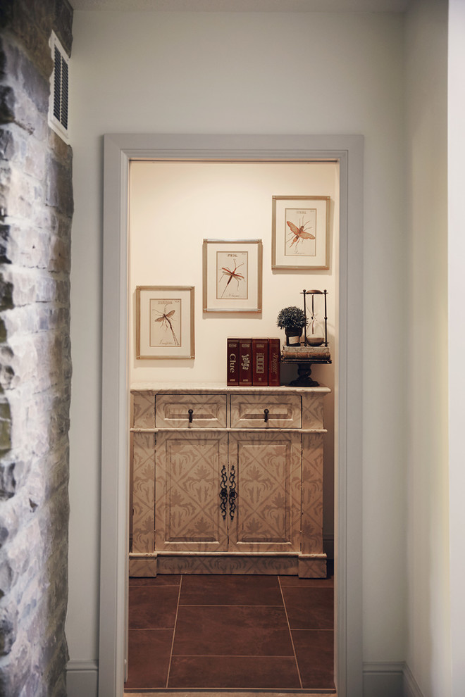 Mid-sized mountain style ceramic tile and brown floor hallway photo with white walls