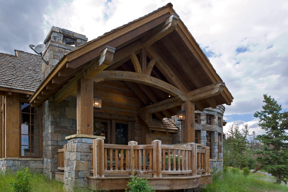 Inspiration for a rustic side yard balcony deck remodel with a roof extension