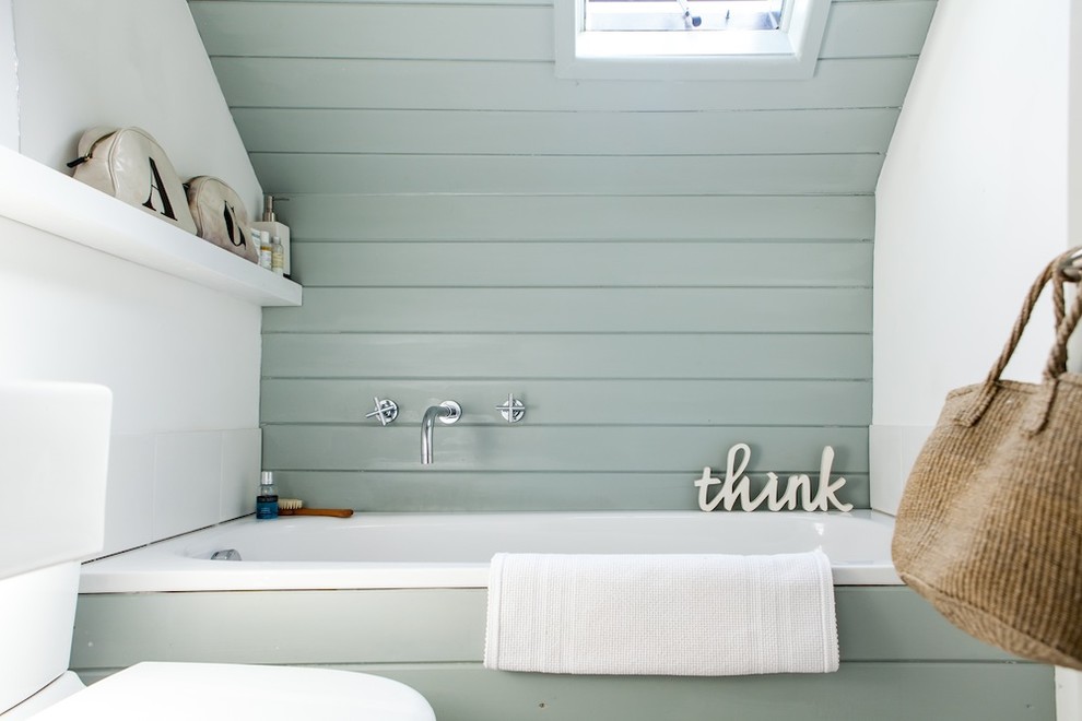 Inspiration for a beach style bathroom in Kent with an alcove tub and blue walls.