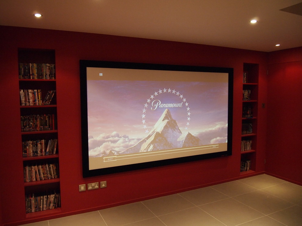 Design ideas for a small modern enclosed home theatre in Surrey with a projector screen.
