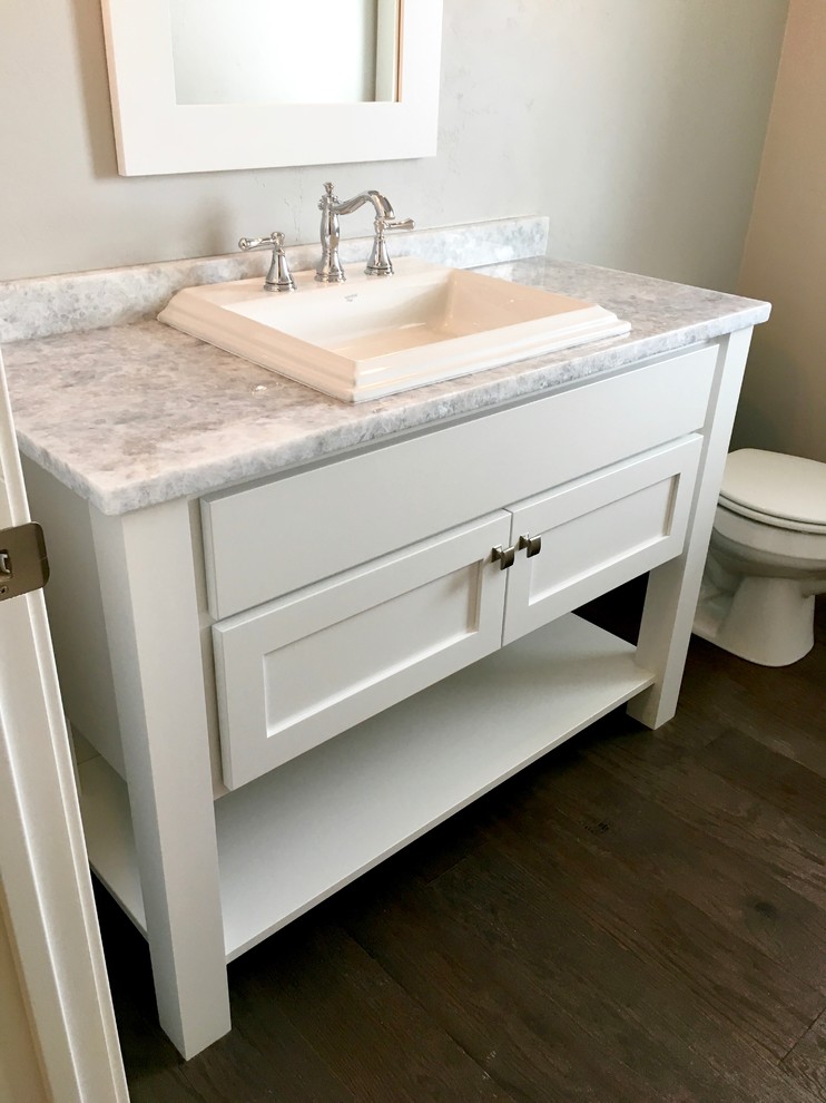 Photo of an arts and crafts powder room in Other with gray tile, grey walls, vinyl floors, granite benchtops, white cabinets and a drop-in sink.
