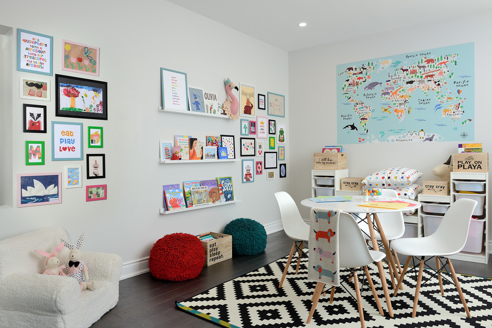 This is an example of a scandinavian kids' playroom for kids 4-10 years old and girls in Toronto with grey walls, dark hardwood floors and brown floor.