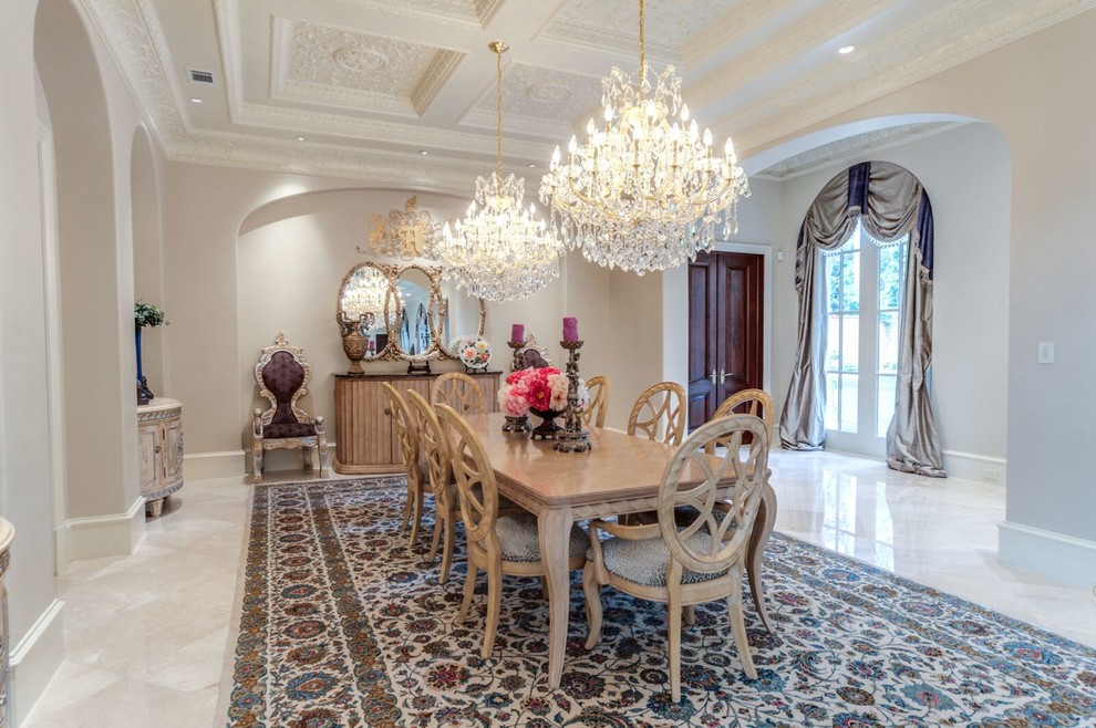 Design ideas for a traditional dining room in Houston with beige walls, marble floors and no fireplace.
