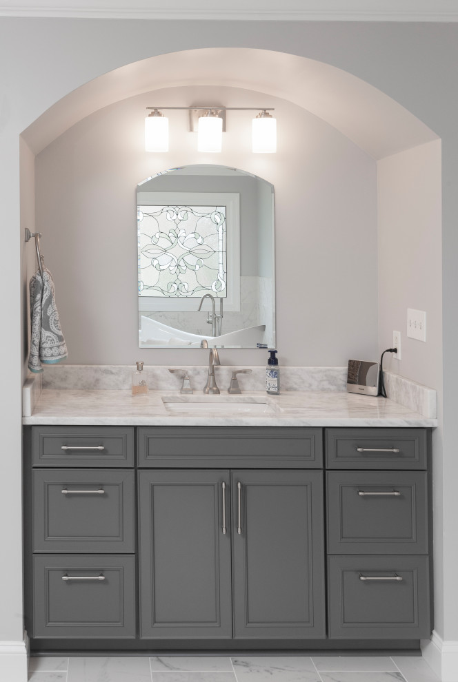 Design ideas for an expansive contemporary master bathroom in Atlanta with shaker cabinets, grey cabinets, a freestanding tub, a double shower, a two-piece toilet, white tile, porcelain tile, grey walls, marble floors, an undermount sink, marble benchtops, white floor and white benchtops.