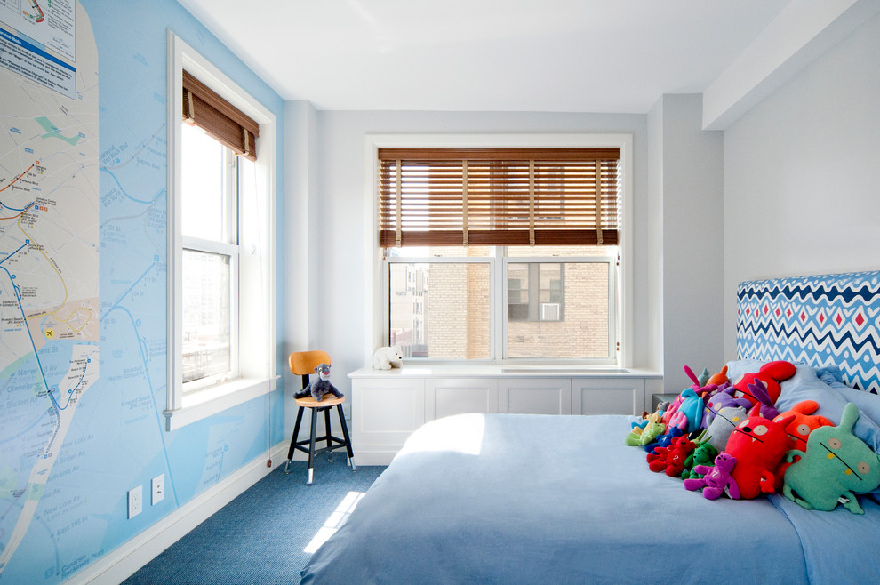 Example of a bedroom and mid-sized transitional boy carpeted and blue floor kids' bedroom design in New York with blue walls
