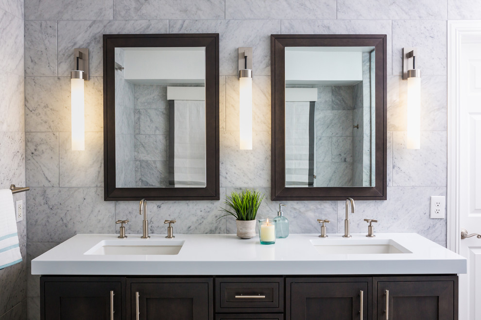 Design ideas for a large transitional master bathroom in Denver with recessed-panel cabinets, dark wood cabinets, a freestanding tub, a corner shower, an urinal, gray tile, marble, white walls, porcelain floors, an undermount sink, engineered quartz benchtops, grey floor, a hinged shower door and white benchtops.