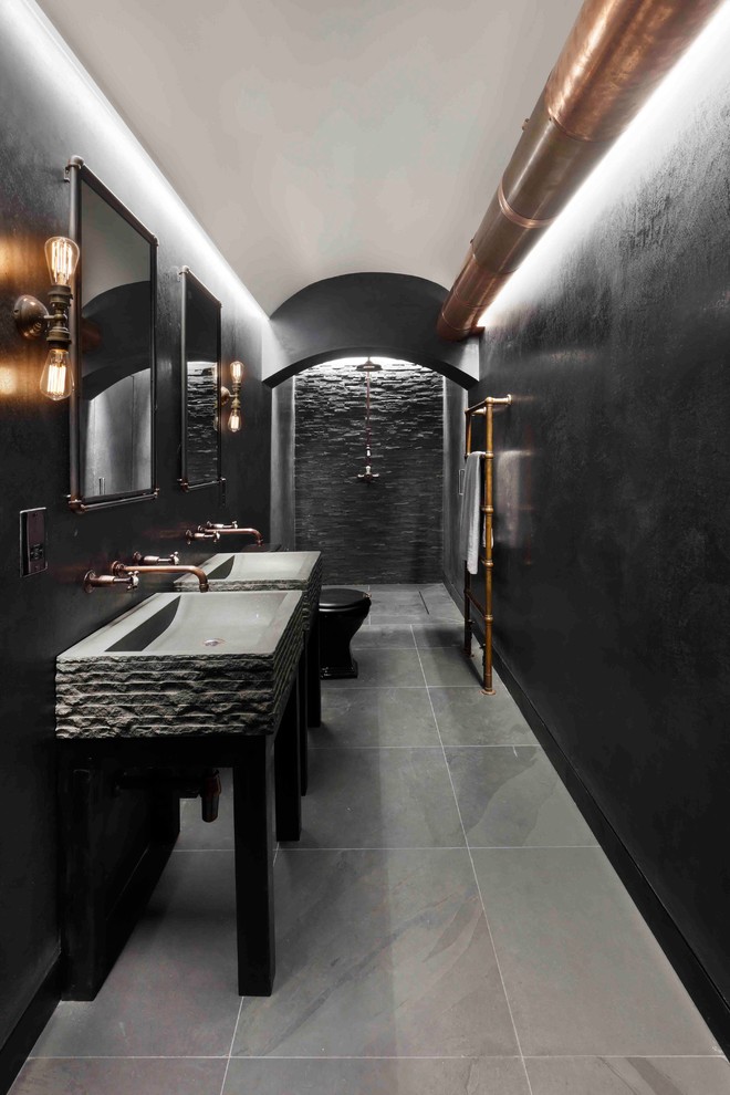 Design ideas for an industrial kids wet room bathroom in London with a two-piece toilet, black tile, slate, black walls, slate floors, a pedestal sink, black floor and an open shower.