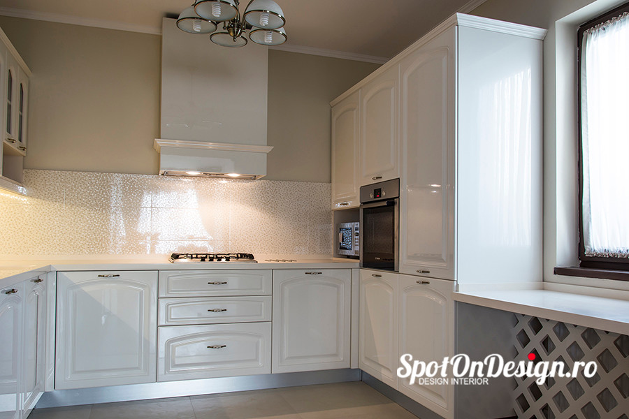 Photo of a small eclectic u-shaped separate kitchen in Other with a single-bowl sink, louvered cabinets, white cabinets, laminate benchtops, white splashback, glass sheet splashback, white appliances and ceramic floors.
