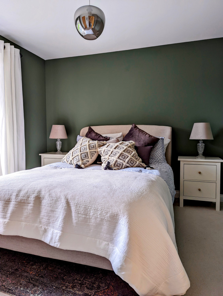 Inspiration for a medium sized traditional guest bedroom in Surrey with green walls, carpet and beige floors.