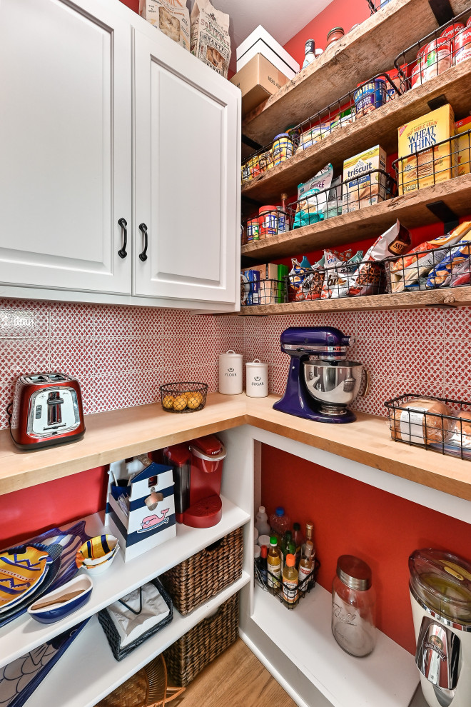 Inspiration for a small traditional l-shaped kitchen pantry in Milwaukee with shaker cabinets, white cabinets, wood worktops, red splashback, ceramic splashback, integrated appliances, vinyl flooring, brown floors and brown worktops.