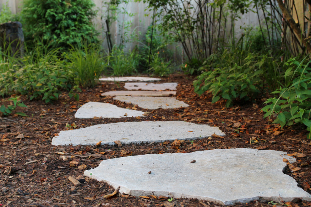 Design ideas for a mid-sized rustic partial sun backyard stone formal garden in Chicago.