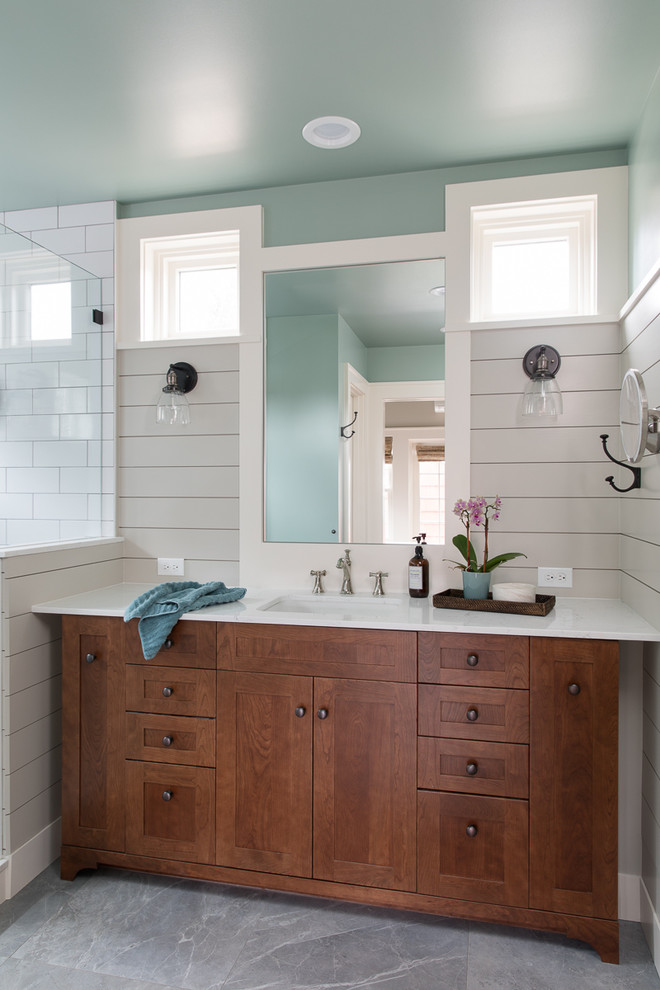 Mid-sized country master bathroom in Seattle with furniture-like cabinets, medium wood cabinets, a double shower, white tile, subway tile, porcelain floors, an undermount sink, engineered quartz benchtops, grey floor and a hinged shower door.