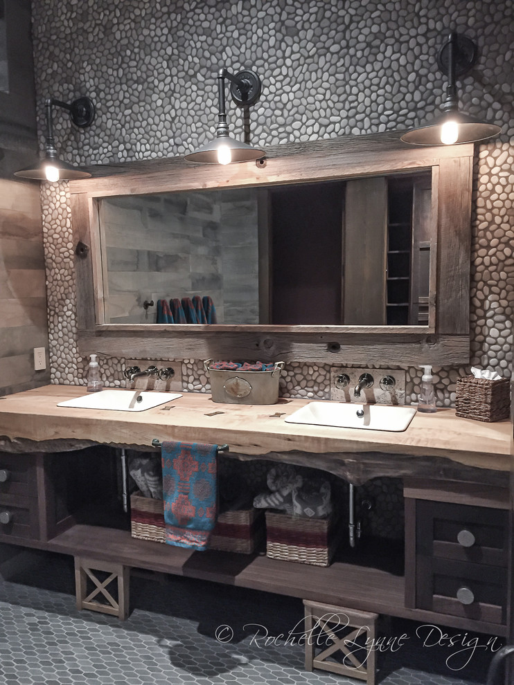 Photo of an expansive country kids bathroom in Calgary with shaker cabinets, distressed cabinets, multi-coloured tile, pebble tile, mosaic tile floors, wood benchtops, a curbless shower, a one-piece toilet and a drop-in sink.