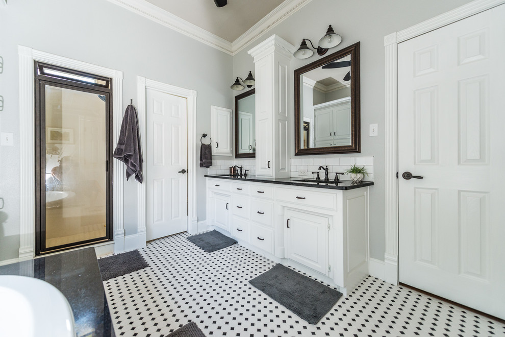 Mid-sized country bathroom in Dallas with raised-panel cabinets, white cabinets, a drop-in tub, black and white tile, ceramic tile, grey walls, dark hardwood floors, an undermount sink, granite benchtops and with a sauna.