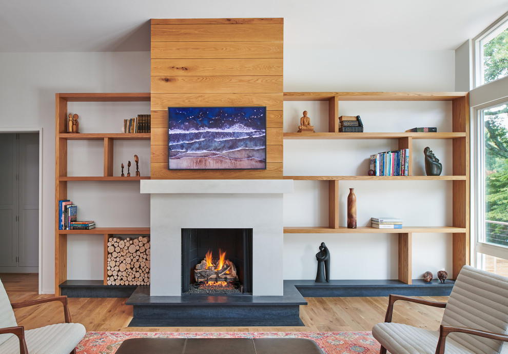 Design ideas for a mid-sized midcentury open concept living room in DC Metro with white walls, light hardwood floors, a standard fireplace, a stone fireplace surround, a built-in media wall and vaulted.