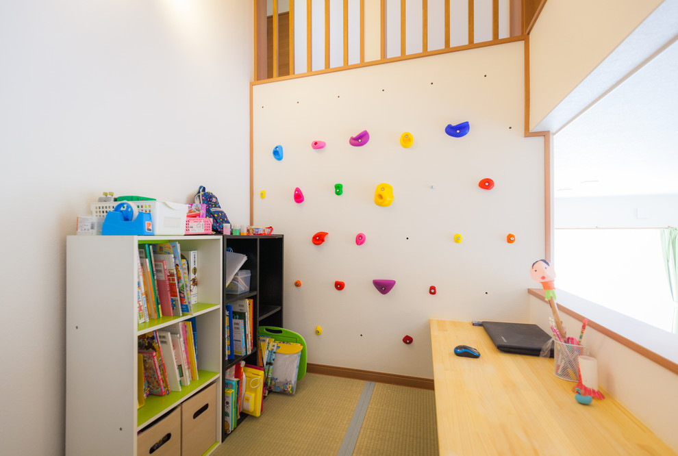 Contemporary gender-neutral kids' playroom in Other with beige walls for kids 4-10 years old.