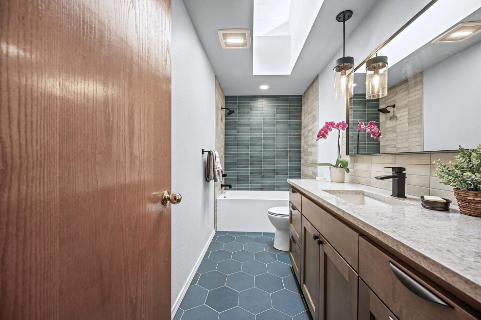 Photo of a mid-sized transitional 3/4 bathroom in Portland with furniture-like cabinets, beige cabinets, an alcove tub, an alcove shower, a two-piece toilet, green tile, ceramic tile, grey walls, ceramic floors, an undermount sink, engineered quartz benchtops, turquoise floor, a shower curtain, grey benchtops, a single vanity and a built-in vanity.