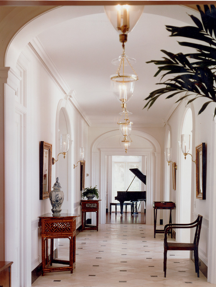 Design ideas for a large traditional hallway in New York with white walls, marble floors and beige floor.