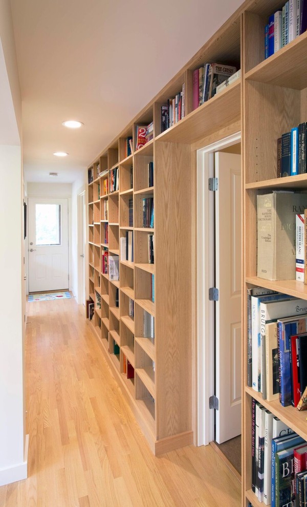 Inspiration for a mid-sized transitional light wood floor hallway remodel in Boston with white walls