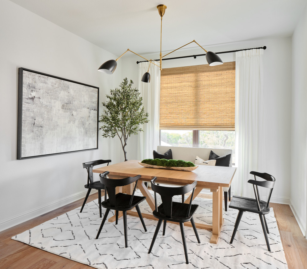 Belterra Project- Furnishings, Light Fixtures & Interior Design - In the breakfast area, a light wood breakfast table contrasts with the black side chairs and dramatic artwork.  A modern light fixture adds an unexpected touch, while long drapes and a woven window shade complete the space.