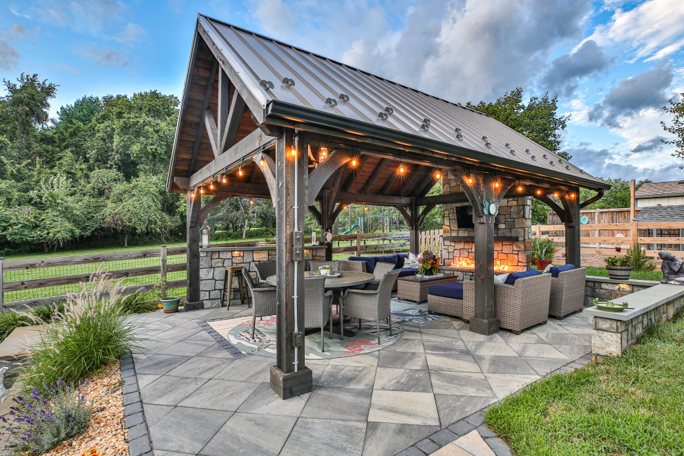 Photo of a country patio in DC Metro with tile and a gazebo/cabana.